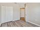 Bedroom featuring wood-look floors and a double-door closet at 6447 Cypressdale Dr # 202, Riverview, FL 33578