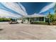Exterior view of a clubhouse with ample parking, lush landscaping, and a welcoming entrance at 6447 Cypressdale Dr # 202, Riverview, FL 33578