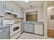 Bright kitchen with white appliances, gray cabinets, and granite countertops at 6447 Cypressdale Dr # 202, Riverview, FL 33578