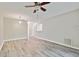 Open-concept living room featuring wood floors and a ceiling fan at 6447 Cypressdale Dr # 202, Riverview, FL 33578