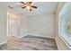 Bright bedroom with modern ceiling fan, wood floors, and a large window at 6447 Cypressdale Dr # 202, Riverview, FL 33578