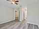 Spacious bedroom with updated ceiling fan, wood floors, and closet space at 6447 Cypressdale Dr # 202, Riverview, FL 33578