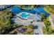 Aerial view showcasing a community pool, clubhouse, playground, and nearby pond, perfect for Gathering recreation at 6447 Cypressdale Dr # 202, Riverview, FL 33578