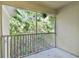 Screened patio features concrete floors and railings at 6447 Cypressdale Dr # 202, Riverview, FL 33578