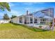 Spacious backyard with screened pool, white fence, and plenty of room for outdoor activities at 703 June Lake Ln, Brandon, FL 33510