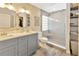 Stylish bathroom with a double vanity, modern lighting, and a sleek glass-enclosed shower at 703 June Lake Ln, Brandon, FL 33510