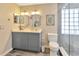 Elegant bathroom featuring a double vanity, modern fixtures, and a glass-enclosed walk-in shower at 703 June Lake Ln, Brandon, FL 33510
