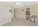 Bedroom featuring neutral colored carpet and walls, ceiling fan, a closet and display shelves at 703 June Lake Ln, Brandon, FL 33510