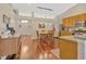Open dining area with hardwood floors, pendant lighting, and view into the entryway and kitchen at 703 June Lake Ln, Brandon, FL 33510