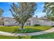 View of the side yard, showcasing the green lawn and a partial view of the house and fencing at 703 June Lake Ln, Brandon, FL 33510