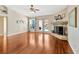 Bright living room with a stone fireplace, wood floors and glass doors leading to the pool at 703 June Lake Ln, Brandon, FL 33510