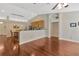 Spacious living area with a view of the adjacent kitchen and dining area featuring hardwood floors at 703 June Lake Ln, Brandon, FL 33510