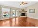 Sunlit living room with wood floors, stone fireplace and large windows overlooking the pool at 703 June Lake Ln, Brandon, FL 33510