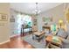 Comfortable living room with hardwood floors, large windows, and a cozy seating area at 703 June Lake Ln, Brandon, FL 33510