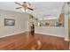 Open concept living area with wood floors connecting the living room to the kitchen at 703 June Lake Ln, Brandon, FL 33510