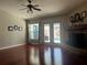 Bright living room with hardwood floors, a fireplace, and French doors leading to the pool area at 703 June Lake Ln, Brandon, FL 33510