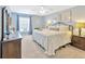 Tranquil bedroom with a large window, neutral carpeting and a cozy, inviting ambiance at 703 June Lake Ln, Brandon, FL 33510