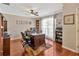 Bright office with hardwood floors, ceiling fan, and built-in bookcase near a window at 703 June Lake Ln, Brandon, FL 33510