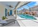 Relaxing screened pool area with a sun shelf, water feature, comfortable seating, and access to the home at 703 June Lake Ln, Brandon, FL 33510