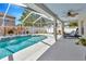 Lovely screened pool area with a sun shelf, comfortable seating, and view of the backyard at 703 June Lake Ln, Brandon, FL 33510