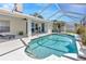 Inviting screened pool area with a sun shelf, comfortable seating, and access to the home at 703 June Lake Ln, Brandon, FL 33510