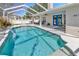 Beautiful screened pool area with a sun shelf, comfortable seating, and access to the home at 703 June Lake Ln, Brandon, FL 33510