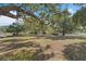 The sprawling backyard features a storage shed, mature trees, and lush grass at 7143 Sealawn Dr, Spring Hill, FL 34606