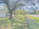 Expansive backyard with mature trees and chain-link fence, perfect for outdoor activities at 7143 Sealawn Dr, Spring Hill, FL 34606