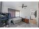 This bedroom has a ceiling fan, hard flooring, a rug, with a rack for hanging clothes at 7143 Sealawn Dr, Spring Hill, FL 34606
