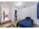 This bedroom has a blue comforter, a rug, and a closet, with an adjacent room visible through a doorway at 7143 Sealawn Dr, Spring Hill, FL 34606