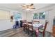 Dining area with updated laminate flooring, comfortable seating, and ample space for entertaining at 7143 Sealawn Dr, Spring Hill, FL 34606