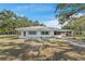 Well-maintained single-story home featuring a carport, brick accents, and neat landscaping at 7143 Sealawn Dr, Spring Hill, FL 34606