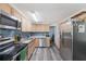 Well-equipped kitchen featuring stainless steel appliances, ample counter space, and wooden cabinets at 7143 Sealawn Dr, Spring Hill, FL 34606