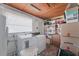 This laundry room features a washer and dryer, shelves, a window, and storage boxes at 7143 Sealawn Dr, Spring Hill, FL 34606