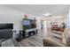 Open living space showcasing laminate flooring, neutral tones, and seamless flow to the dining area at 7143 Sealawn Dr, Spring Hill, FL 34606