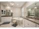 Bright bathroom featuring dual sink vanities, soaking tub, granite countertops, and modern fixtures at 8766 Capstone Ranch Dr, New Port Richey, FL 34655