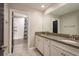 Bright bathroom boasts double sinks with granite countertops and a shower over tub at 8766 Capstone Ranch Dr, New Port Richey, FL 34655