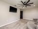Neutral bedroom with a TV, ceiling fan, and access to the other rooms in the house at 8766 Capstone Ranch Dr, New Port Richey, FL 34655