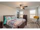 Bright bedroom with matching nautical comforter and pillowcases, wood furniture, and a ceiling fan at 8766 Capstone Ranch Dr, New Port Richey, FL 34655