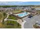 Aerial view of community pool, clubhouse, playground, and common green space in a Gathering friendly neighborhood at 8766 Capstone Ranch Dr, New Port Richey, FL 34655