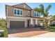 Charming two-story home with a brick paver driveway and well-manicured lawn at 8766 Capstone Ranch Dr, New Port Richey, FL 34655