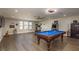 Spacious game room with a pool table, arcade games, and exercise equipment at 8766 Capstone Ranch Dr, New Port Richey, FL 34655