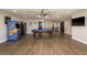 Large game room featuring a pool table, arcade games, TV, and hardwood floors at 8766 Capstone Ranch Dr, New Port Richey, FL 34655