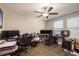 Home office with multiple monitors, two desks, hardwood flooring and a ceiling fan at 8766 Capstone Ranch Dr, New Port Richey, FL 34655