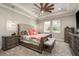 Comfortable main bedroom featuring a tray ceiling, ceiling fan, carpet, and updated furniture at 8766 Capstone Ranch Dr, New Port Richey, FL 34655