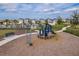 A playground with swings, slides, and green safety ground, perfect for active fun at 8766 Capstone Ranch Dr, New Port Richey, FL 34655