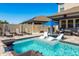 Backyard pool area features in-pool loungers and a nearby hot tub and covered patio seating at 8766 Capstone Ranch Dr, New Port Richey, FL 34655