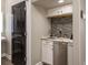 Close up of wet bar with white cabinets, tile backsplash and stainless steel beverage center at 8766 Capstone Ranch Dr, New Port Richey, FL 34655