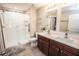 Elegant bathroom featuring a double vanity, walk-in shower, and lots of natural light at 17113 Sunshine Mimosa St, Wimauma, FL 33598