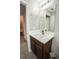 Bathroom featuring a vanity sink and large mirror at 17113 Sunshine Mimosa St, Wimauma, FL 33598